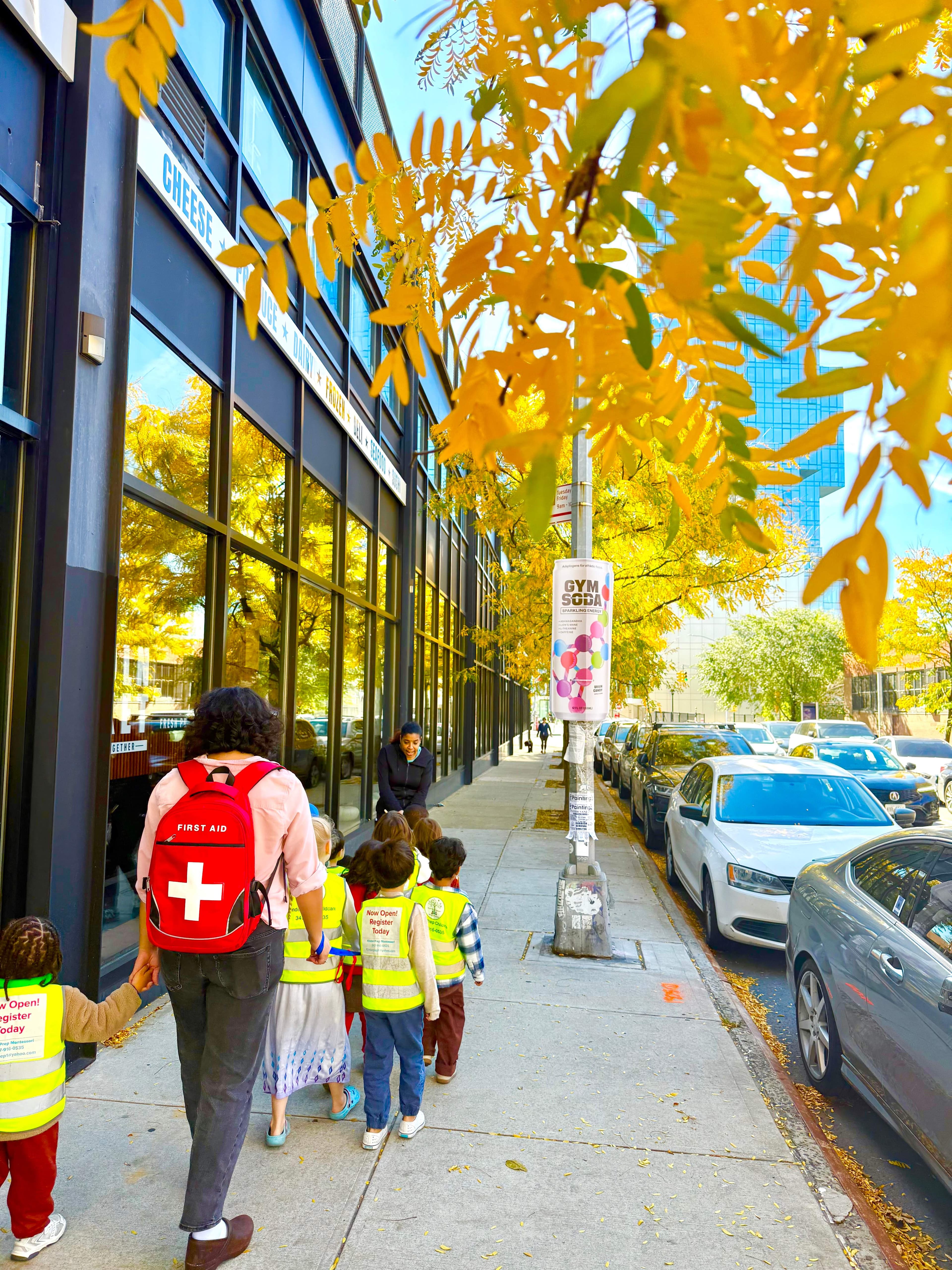 Children exploring autumn leaves on a neighborhood walk