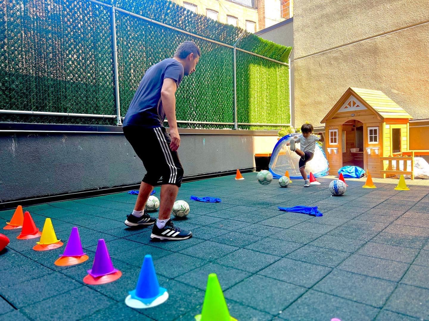 Kids learning soccer on rooftop playground