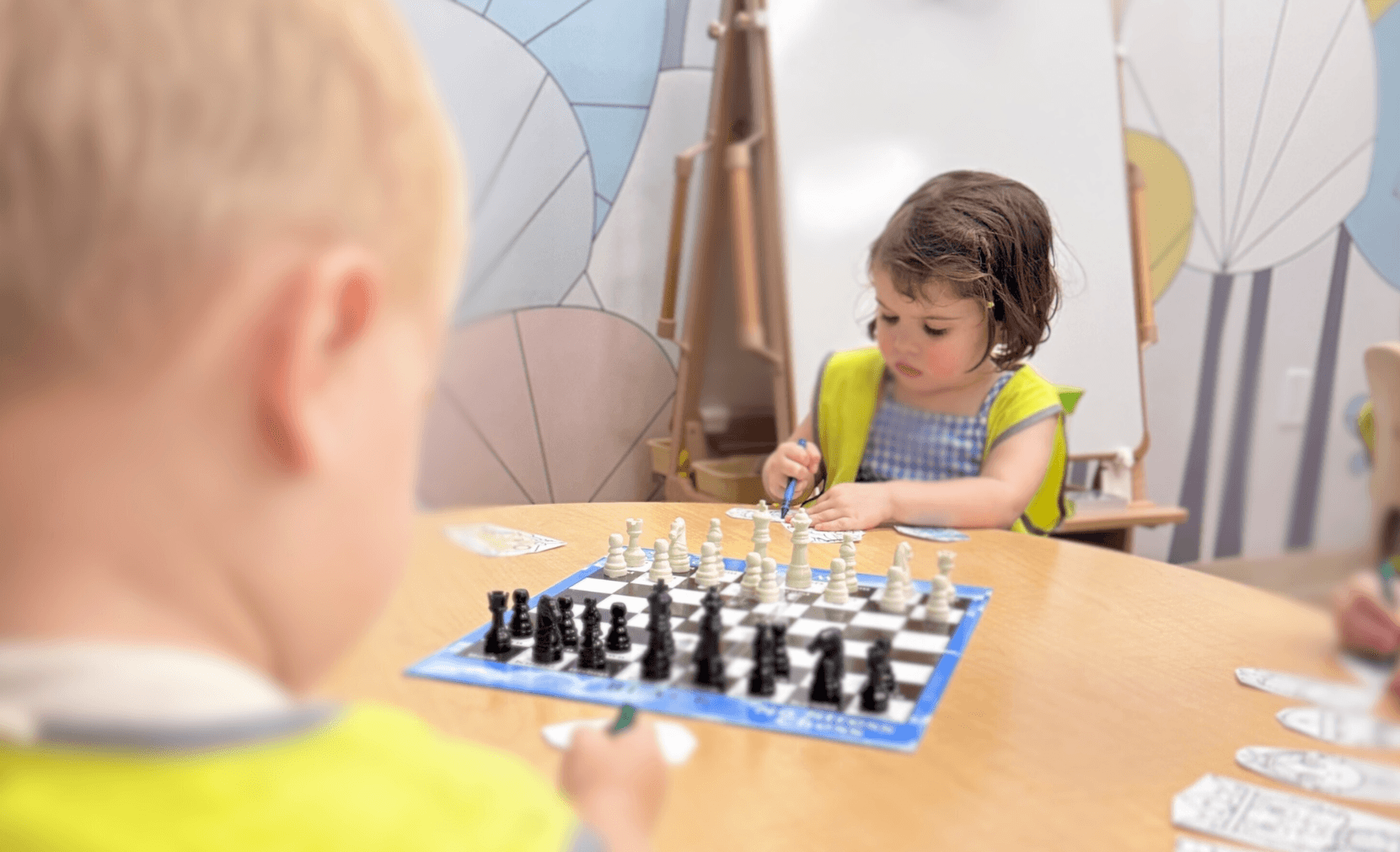 Children learning to play chess together for cognitive development